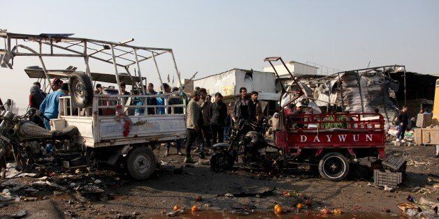 BAGHDAD, IRAQ - JANUARY 8: Iraqis inspect the scene of car bomb attack at a market in Baghdad, Iraq on January 8, 2017. At least ten civilians were killed and 18 others injured when a car bomb detonated near a public market in eastern Baghdad, according to a security source. (Photo by Amir Saadi /Anadolu Agency/Getty Images)