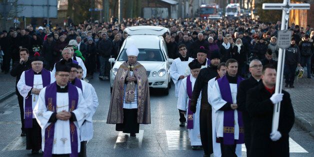 Mourners attend the funeral of Lukasz Urban, the Polish truck driver who was killed in the Berlin Christmas market attack, in Banie near Sczczecin, Poland, on December 30, 2016.Lukasz Urban was shot dead probably by suspected jihadist killer Anis Amri shortly before the market attack, in which 11 other people were killed and almost 50 injured when the truck tore through the crowd, smashing wooden stalls and crushing victims, in scenes reminiscent of July's deadly attack in the French Riviera city of Nice. / AFP / Odd ANDERSEN (Photo credit should read ODD ANDERSEN/AFP/Getty Images)