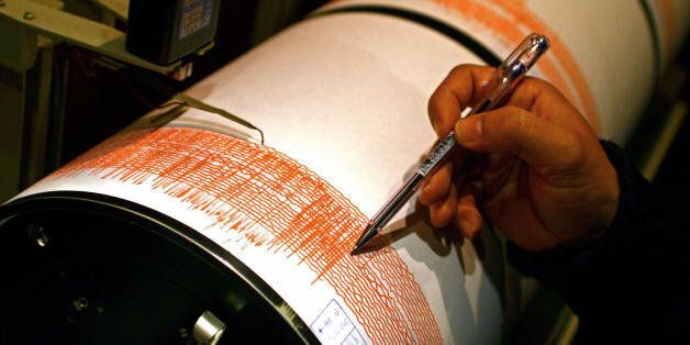 Lisbon, PORTUGAL: Portuguese seismologist Carlos Corela shows on a seismograph of the Instituto Geofisico in Lisbon 12 February 2007, the moment where an earthquake measuring 6.0 on the Richter scale struck off the southern coast of Portugal.No casualties or major damage to buildings were reported in the aftermath of the tremor, which occurred at 10:36 am (1036 GMT) some 160 kilometres (100 miles) east of the Cape Saint Vincent in Portugal's southernmost province of Algarve. The earthquake was felt in the Portuguese capital Lisbon as well as in southern Spain and Morocco. AFP PHOTO/ NICOLAS ASFOURI (Photo credit should read NICOLAS ASFOURI/AFP/Getty Images)