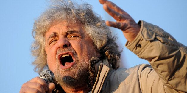 Five-Star Movement leader and comedian Beppe Grillo gestures during a rally in Turin, Italy February 16, 2013. REUTERS/Giorgio Perottino/File Photo