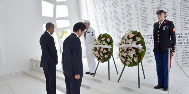 US President Barack Obama(L) and Japanese Prime Minister Shinzo Abe place wreaths at the USS Arizona Memorial December 27, 2016 at Pearl Harbor in Honolulu, Hawaii. Abe and Obama made a joint pilgrimage to the site of the Pearl Harbor attack on Tuesday to celebrate 'the power of reconciliation. 'The Japanese attack on an unsuspecting US fleet moored at Pearl Harbor turned the Pacific into a cauldron of conflict -- more than 2,400 were killed and a reluctant America was drawn into World War II. / AFP / Nicholas Kamm (Photo credit should read NICHOLAS KAMM/AFP/Getty Images)