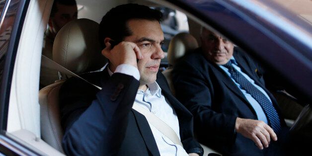 Greek radical left unified party President Alexis Tsipras (L) talks on his mobile phone as he arrives for a news conference for foreign press during his visit in Rome February 7, 2014. REUTERS/Alessandro Bianchi (ITALY - Tags: POLITICS)