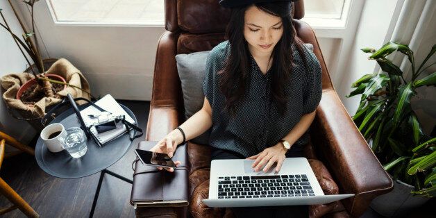 High angle view of creative businesswoman working while sitting on chair