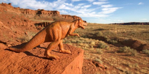 Toy dinosaur on rock outdoors in Utah