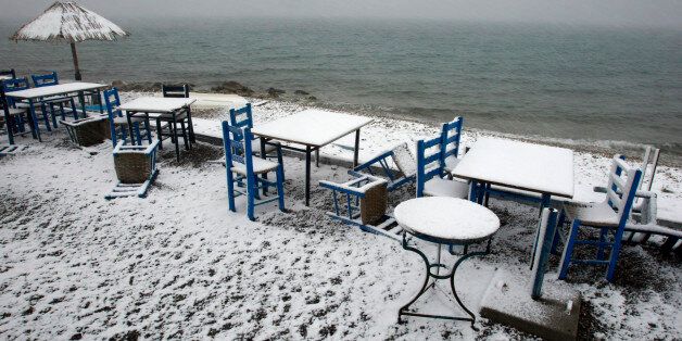 A seaside tavern is seen covered by snow at Oropos village, northeast of Athens February 17, 2008. REUTERS/Yiorgos Karahalis (GREECE)