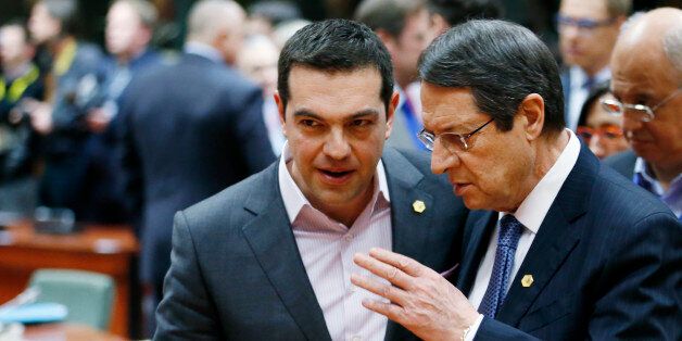Greece's Prime Minister Alexis Tsipras listens to Cyprus' President Nicos Anastasiades (R) during a European Union leaders summit in Brussels March 19, 2015. REUTERS/Francois Lenoir