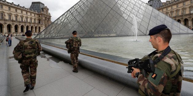 French army soldiers patrol near the Louvre Museum Pyramid's main entrance in Paris, France, June 13, 2016 as the French capital is under high security during the UEFA 2016 European Championship. REUTERS/Philippe Wojazer