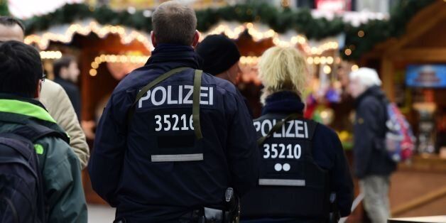 Police officers walk at the christmas market near the Kaiser-Wilhelm-Gedaechtniskirche (Kaiser Wilhelm Memorial Church) in Berlin on December 22, 2016.The Berlin Christmas market that was struck by a deadly truck rampage on December 19, 2016 reopened, as the grieving city sought a return to normal life and police hunted for the prime suspect in the attack. / AFP / Tobias SCHWARZ (Photo credit should read TOBIAS SCHWARZ/AFP/Getty Images)