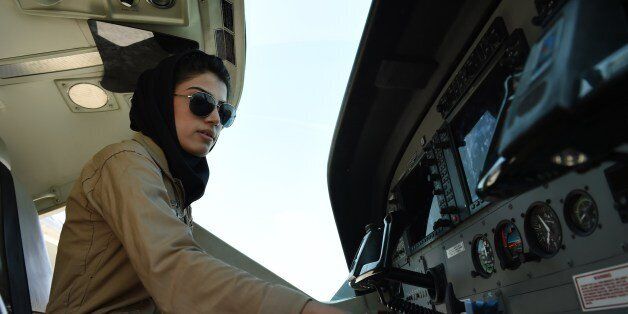 TO GO WITH AFGHANISTAN-UNREST-WOMEN-AVIATION BY ANUJ CHOPRA In a picture taken on April 26, 2015, Afghanistan's first female pilot Niloofar Rahmani, 23, sits in a fixed-wing Afghan Air Force aviator aircraft in Kabul. With a hint of swagger in her gait, Afghanistan's first female pilot since the ouster of the Taliban is defying death threats and archaic gender stereotypes to infiltrate an almost entirely male preserve. AFP PHOTO / SHAH Marai (Photo credit should read SHAH MARAI/AFP/Getty
