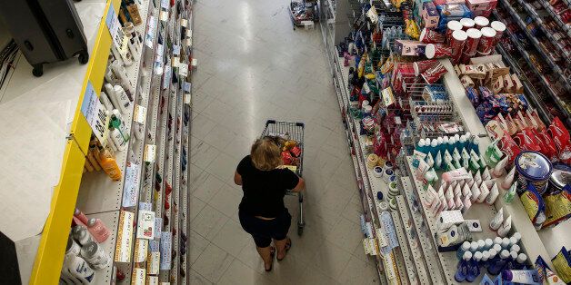 A customer pushes a shopping cart along a food aisle while shopping inside a local supermarket in Athens, Greece, on Friday, July 3, 2015. Shortages of commodities of broad consumption such as imported meat, beans, rice will start to be felt next week, EKathimerini says, citing unidentified people from the retail commerce sector. Photographer: Yorgos Karahalis/Bloomberg via Getty Images