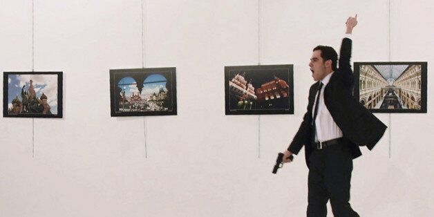 EDITORS NOTE: Graphic content / A picture taken on December 19, 2016 shows Mevlut Mert Altintas, the gunman who killed Russia's Ambassador to Turkey, during an attack during a public event in Ankara.A gunman crying 'Aleppo' and 'revenge' shot Karlov while he was visiting an art exhibition in Ankara on December 19, witnesses and media reports said. The Turkish state-run Anadolu news agency said the gunman had been 'neutralised' in a police operation, without giving further details. / AFP / Sozcu daily / Yavuz Alatan / Turkey OUT (Photo credit should read YAVUZ ALATAN/AFP/Getty Images)