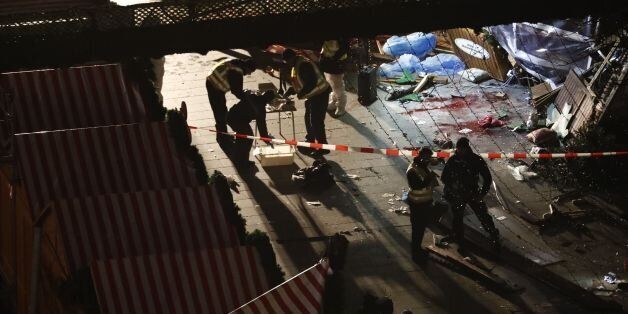 Authorites inspect a truck that had sped into a Christmas market in Berlin, on December 19, 2016, killing at least nine people and injuring dozens more.Ambulances and heavily armed officers rushed to the area after the driver drove up the pavement of the market in a square popular with tourists, in scenes reminiscent of the deadly truck attack in the French city of Nice last July. / AFP / Odd ANDERSEN (Photo credit should read ODD ANDERSEN/AFP/Getty Images)