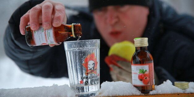 IVANOVO, RUSSIA - DECEMBER 19, 2016: A man pours Hawthorn infusion into a glass. The Russian Government demanded to withdraw the Hawthorn infusion and other alcohol containing products from retail after a deadly poisoning in Irkutsk. Vladimir Smirnov/TASS (Photo by Vladimir Smirnov\TASS via Getty Images)