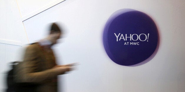 A man walks past a Yahoo logo during the Mobile World Congress in Barcelona, Spain, February 24, 2016. REUTERS/Albert Gea/File Photo