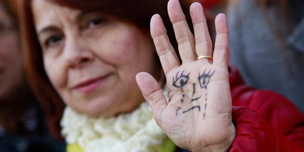 ANKARA, TURKEY - 2016/11/22: A Woman show their hand painted to represent a child's face, Thousands of people protested the government outside the Turkey's parliament building for a draft law about the remission of some people imprisoned for under aged rape. The Turkish government had propose to set aside the convictions of men imprisoned for child sex assaults if they marry their victim with the consent of the family. Following a public outcry, Turkey's government has withdrawn to law design. (Photo by Basin Foto Ajansi/LightRocket via Getty Images)