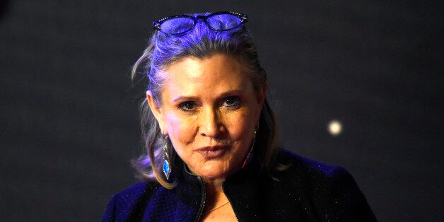 Carrie Fisher poses for cameras as she arrives at the European Premiere of Star Wars, The Force Awakens in Leicester Square, London, December 16, 2015. REUTERS/Paul Hackett