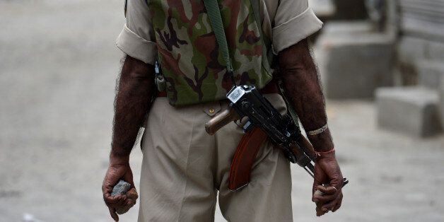 An Indian paramilitary officer holds stones in his hands during a clash with protesters in Srinagar on July 10, 2016.The death toll from unrest in Indian-administered Kashmir climbed to 15 July 10, officials said, despite authorities imposing a harsher curfew on the restive territory in a bid to prevent new demonstrations. One protestor was killed on July 10 when government forces fired on angry residents who defied the restrictions in the southern Pulwama area, and six died in different hospitals overnight after suffering gunshot wounds on July 9, a police officer said, speaking on condition of anonymity. / AFP / TAUSEEF MUSTAFA (Photo credit should read TAUSEEF MUSTAFA/AFP/Getty Images)