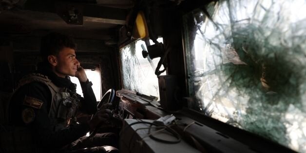 A soldier of the Iraqi Special Forces drives an armoured vehicle in the Aden district of Mosul after troops almost entirely retook the area from Islamic State (IS) group jihadists following heavy fighting on November 22, 2016.The fighting inside the city so far has focused on eastern neighbourhoods, which elite counter-terrorism and army forces entered earlier this month.The Islamic State group has offered fierce resistance to defend its last remaining bastion in Iraq, the city where its leader Abu Bakr al-Baghdadi proclaimed a caliphate in June 2014. / AFP / THOMAS COEX (Photo credit should read THOMAS COEX/AFP/Getty Images)