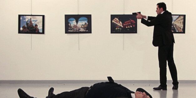 EDITORS NOTE: Graphic content / This picture taken on December 19, 2016 shows Andrey Karlov (bottom), the Russian ambassador to Ankara, lying on the floor after being shot by a gunman (R) during an attack during a public event in Ankara.A gunman crying 'Aleppo' and 'revenge' shot Karlov while he was visiting an art exhibition in Ankara on December 19, witnesses and media reports said. The Turkish state-run Anadolu news agency said the gunman had been 'neutralised' in a police operation, without giving further details. / AFP / Hurryet / Hasim KILIC / Turkey OUT (Photo credit should read HASIM KILIC/AFP/Getty Images)