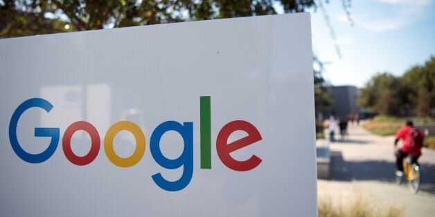 A man rides a bike passed a Google sign and logo at the Googleplex in Menlo Park, California on November 4, 2016. / AFP / JOSH EDELSON (Photo credit should read JOSH EDELSON/AFP/Getty Images)