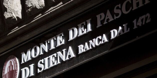 Banca Monte dei Paschi di Siena SpA signage sits above the entrance of a bank branch in Siena, Italy, on Friday, Dec. 16, 2016. The bank will begin taking orders for shares Monday as it aims to complete raising 5 billion euros ($5.2 billion) by the end of the year to avoid a rescue by the Italian government. Photographer: Alessia Pierdomenico/Bloomberg via Getty Images