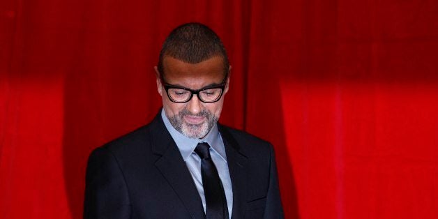 British singer George Michael poses for photographers before a news conference at the Royal Opera House in central London May 11, 2011. REUTERS/Stefan Wermuth (BRITAIN - Tags: ENTERTAINMENT)