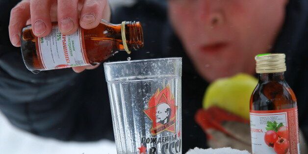 IVANOVO, RUSSIA - DECEMBER 19, 2016: A man pours Hawthorn infusion into a glass. The Russian Government demanded to withdraw the Hawthorn infusion and other alcohol containing products from retail after a deadly poisoning in Irkutsk. Vladimir Smirnov/TASS (Photo by Vladimir Smirnov\TASS via Getty Images)