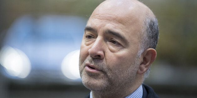 Pierre Moscovici, economic commissioner for the European Union (EU), speaks to members of the media as he arrives ahead of a Eurogroup meeting of European finance ministers in Brussels, Belgium, on Monday, Dec. 5, 2016. Since Greece's debt triggered a wave of shocks that spooked investors in Europe more than six years ago, EU governments -- led by Angela Merkel's Germany, the bloc's largest economy -- have been pursuing an austerity-first agenda; not only raising taxes, slashing spending and str