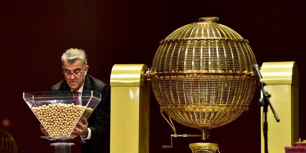 An official prepares the balls with the numbers before the draw of Spain's Christmas lottery named 'El Gordo' (Fat One) in Madrid, on December 22, 2016.The Gordo lottery first took place in 1812 in Cadiz and has not missed a year since, continuing through Spains civil war between 1936 and 1939. In 1938, there were actually two Christmas lotteries, one held in Burgos by dictator General Francos Nationalist regime, and the other in Republican-ruled Barcelona. / AFP / GERARD JULIEN (Photo credit should read GERARD JULIEN/AFP/Getty Images)