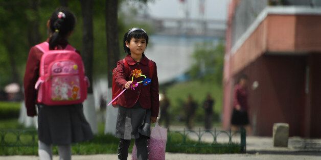PYONGYANG, NORTH KOREA - MAY 9: Young girls walk by themselves without adults in Pyongyang, North Korea on May 9, 2016. It's not uncommon to see young kids walking in public alone in North Korea. Some Koreans say they have no worries that the streets or the people on them are unsafe. (Photo by Linda Davidson / The Washington Post via Getty Images)