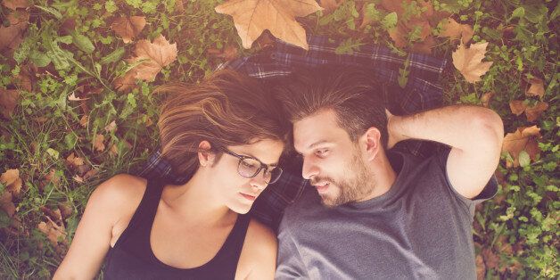 Happy couple lying on the grass