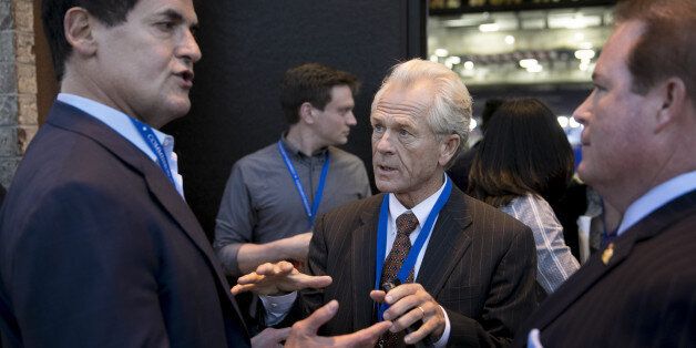 Peter Navarro, senior economic advisor to 2016 Republican Presidential Nominee Donald Trump, center, speaks with Mark Cuban, billionaire owner of the National Basketball Association's (NBA) Dallas Mavericks basketball team, left, outside the media filing center ahead of the first U.S. presidential debate at Hofstra University in Hempstead, New York, U.S., on Monday, Sept. 26, 2016. Trump and Hillary Clinton are locked in a tied two-way race for the presidency as they head into one of the most hi