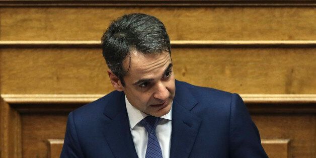 Kyriakos Mitsotakis, leader of conservative main opposition New Democracy party, addresses lawmakers during a parliamentary session in Athens, Saturday, Dec. 10, 2016. Greek parliament votes on 2017 budget, as the country's left-wing government is still negotiating a new series of cost-cutting reforms that are expected to remove protection measures for private sector jobs and distressed mortgage holders. (AP Photo/Yorgos Karahalis)