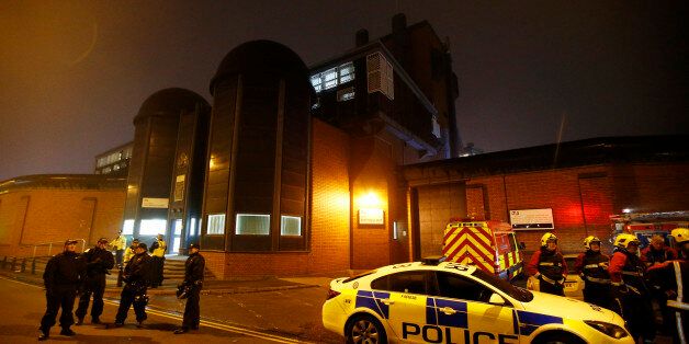Police officers and firemen stand outside Winson Green prison, run by security firm G4S, after a serious disturbance broke out, in Birmingham, Britain, December 16, 2016. REUTERS/Peter Nicholls