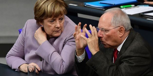 German Chancellor Angela Merkel talks with German Finance Minister Wolfgang Schaeuble during a session at the Bundestag (lower house of parliament) in Berlin on November 25, 2016, during a week of budget debate. / AFP / TOBIAS SCHWARZ (Photo credit should read TOBIAS SCHWARZ/AFP/Getty Images)