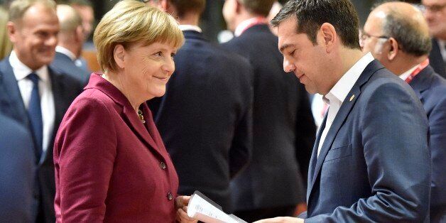 German Chancellor Angela Merkel, left, smiles to Greek Prime Minister Alexis Tsipras, right, during the EU summit in Brussels, Belgium on Thursday, Oct. 15, 2015. European Union heads of state meet to discuss, among other issues, the current migration crisis. (AP Photo/Martin Meissner)