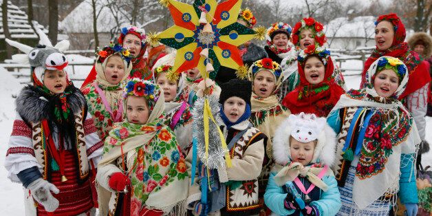 Children dressed in traditional costumes sing Christmas carols as they gather to celebrate the Orthodox Christmas at a compound of the National Architecture museum in Kiev, Ukraine, January 7, 2016. Most Orthodox Christians celebrate Christmas according to the Julian calendar on January 7, two weeks after most western Christian churches that abide by the Gregorian calendar. REUTERS/Valentyn Ogirenko