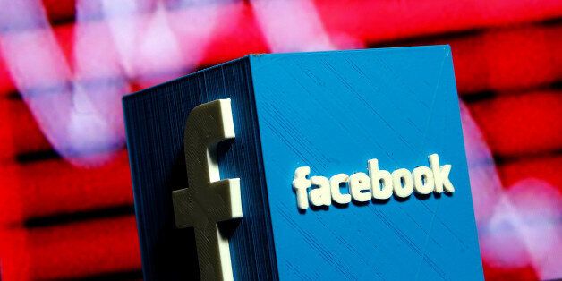 A 3D-printed Facebook logo is seen in front of a displayed stock graph in this illustration taken November 3, 2016. REUTERS/Dado Ruvic/Illustration