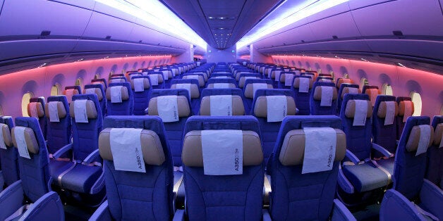 Light-emitting diode (LED) lights illuminate the economy class cabin of an Airbus A350 XWB aircraft, produced by Airbus Group NV, inside a Japan Airlines Co. (JAL) hangar during a media preview at Haneda Airport in Tokyo, Japan, on Thursday, Nov. 20, 2014. JAL ordered 18 A350-900 aircraft and 13 larger A350-1000s President Yoshiharu Ueki told reporters last year. Photographer: Kiyoshi Ota/Bloomberg via Getty Images