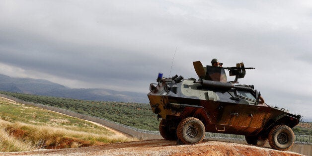 A Turkish soldier on armoured military vehicle patrols the border between Turkey and Syria, near the southeastern village of Besarslan, in Hatay province, Turkey, November 1, 2016. REUTERS/Umit Bektas