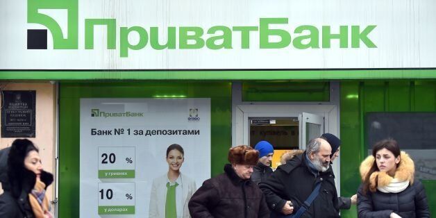 Clients walk out the office of the PrivatBank in the center of Kiev on December 19, 2016. Ukrainian President Petro Poroshenko urged people on December 19 not to panic after his government nationalised the country's largest private bank to avoid a rapid financial meltdown. The former Soviet republic's cabinet on Sunday took over PrivatBank - a lender that held one-third of Ukrainians' bank deposits and even had branches in the Baltic states. / AFP / Sergei SUPINSKY (Photo credit should read SERGEI SUPINSKY/AFP/Getty Images)