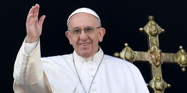 Pope Francis waves from the balcony of St Peter's basilica during the traditional 'Urbi et Orbi' Christmas message to the city and the world, on December 25, 2016 at St Peter's square in Vatican.Pope Francis offered his thoughts to victims of terrorism in his annual Christmas address, days after the truck attack that left 12 dead at a festive Berlin market. / AFP / ANDREAS SOLARO (Photo credit should read ANDREAS SOLARO/AFP/Getty Images)