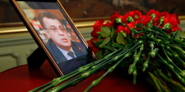 Flowers are placed near a portrait of murdered Russian ambassador to Turkey Andrei Karlov during a meeting of Russian Foreign Minister Sergei Lavrov with his Turkish counterpart Mevlut Cavusoglu in Moscow, Russia, December 20, 2016. REUTERS/Maxim Shemetov