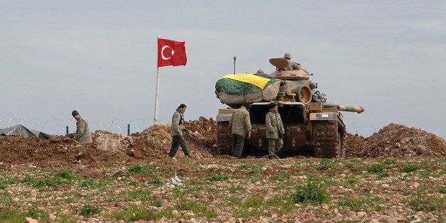 Turkish soldiers and an army tank take position at the new site of the Suleyman Shah tomb near the northern Syrian village of Esme, on the Syrian-Turkish border February 24, 2015. By extracting dozens of its soldiers surrounded by Islamist fighters in Syria, Turkey has warded off a potential crisis and shown its ability to manoeuvre between rival warring parties, including Islamic State. Several hundred Turkish ground troops, backed by tanks and drones, mounted an eight-hour operation on Saturday night to evacuate the 38 soldiers guarding the tomb of Suleyman Shah, grandfather of the founder of the Ottoman Empire. The fact there were no clashes appeared to suggest that Islamic State fighters surrounding the site were either warned or coerced by Turkey not to try to disrupt the incursion, the first it has mounted since Syria's civil war broke out in 2011. The Turkish Foreign Ministry said the tomb had been temporarily moved to a new site within Syria north of the village of Esme, close to the Turkish border. REUTERS/Stringer (TURKEY - Tags: POLITICS MILITARY CONFLICT TPX IMAGES OF THE DAY)