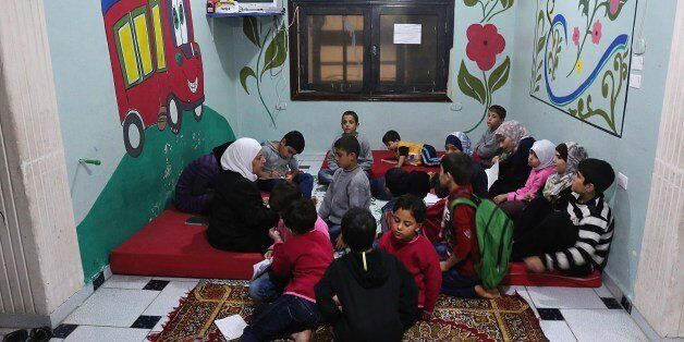Syrian children study at the Mumayazoun (the special ones) children's orphanage in the Salah al-Din neighbourhood in the northern city of Aleppo, on October 25, 2015. The orphanage is currently housing 22 children who lost their parents due to the ongoing conflict, providing them with shelter, education and mental support. AFP PHOTO / BARAA AL-HALABI (Photo credit should read BARAA AL-HALABI/AFP/Getty Images)