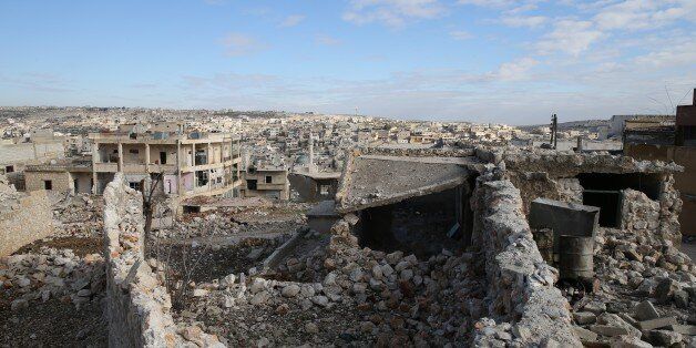 ALEPPO, SYRIA - DECEMBER 18: Debris of the collapsed buildings is seen in the Darat Izza district of Aleppo as the civil war continues in Syria on December 18, 2016. As a result of air attacks from warplanes belonging to the Assad regime, the Darat Izza, a district in western Aleppo that normally houses 100,000 people, has become essentially a ghost town. Destruction in the west of the district has opened the way for attacks. Despite all adverse conditions, the people are staying at home and struggling. The people of the district, whose social spaces such as schools and mosques have been destroyed as a result of air strikes, are struggling for their lives under tough winter conditions as a result of the targeting of their electricity lines. (Photo by Cem Genco/Anadolu Agency/Getty Images)