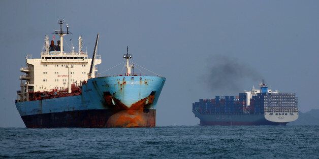 A container ship passes a tanker along the southern coast of Singapore June 8, 2016. REUTERS/Edgar Su