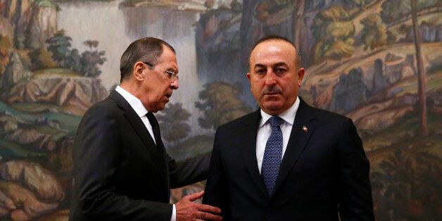 Russian Foreign Minister Sergei Lavrov (L) and his Turkish counterpart Mevlut Cavusoglu attend a ceremony in memory of murdered Russian ambassador to Turkey Andrei Karlov before their talks in Moscow, Russia, December 20, 2016. REUTERS/Maxim Shemetov