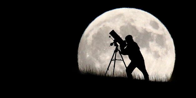 BRIGHTON, UNITED KINGDOM - SEPTEMBER 27: An astronomer stargazes ahead of tonight's supermoon on September 27, 2015 in Brighton, England. Tonight's supermoon, so called because it is the closest full moon to the Earth this year, is particularly rare as it coincides with a lunar eclipse, a combination that has not happened since 1982 and won't happen again until 2033. (Photo by Jordan Mansfield/Getty Images)
