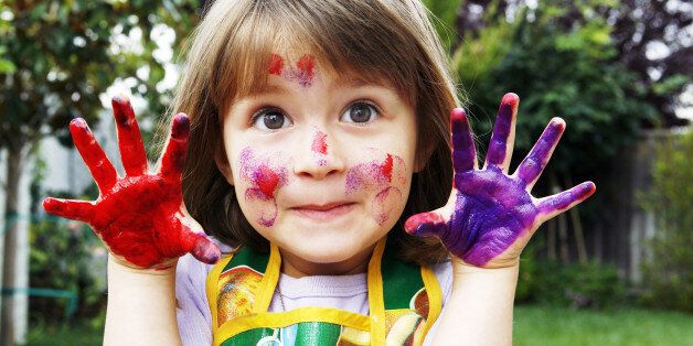 Young girl with painted hands and face
